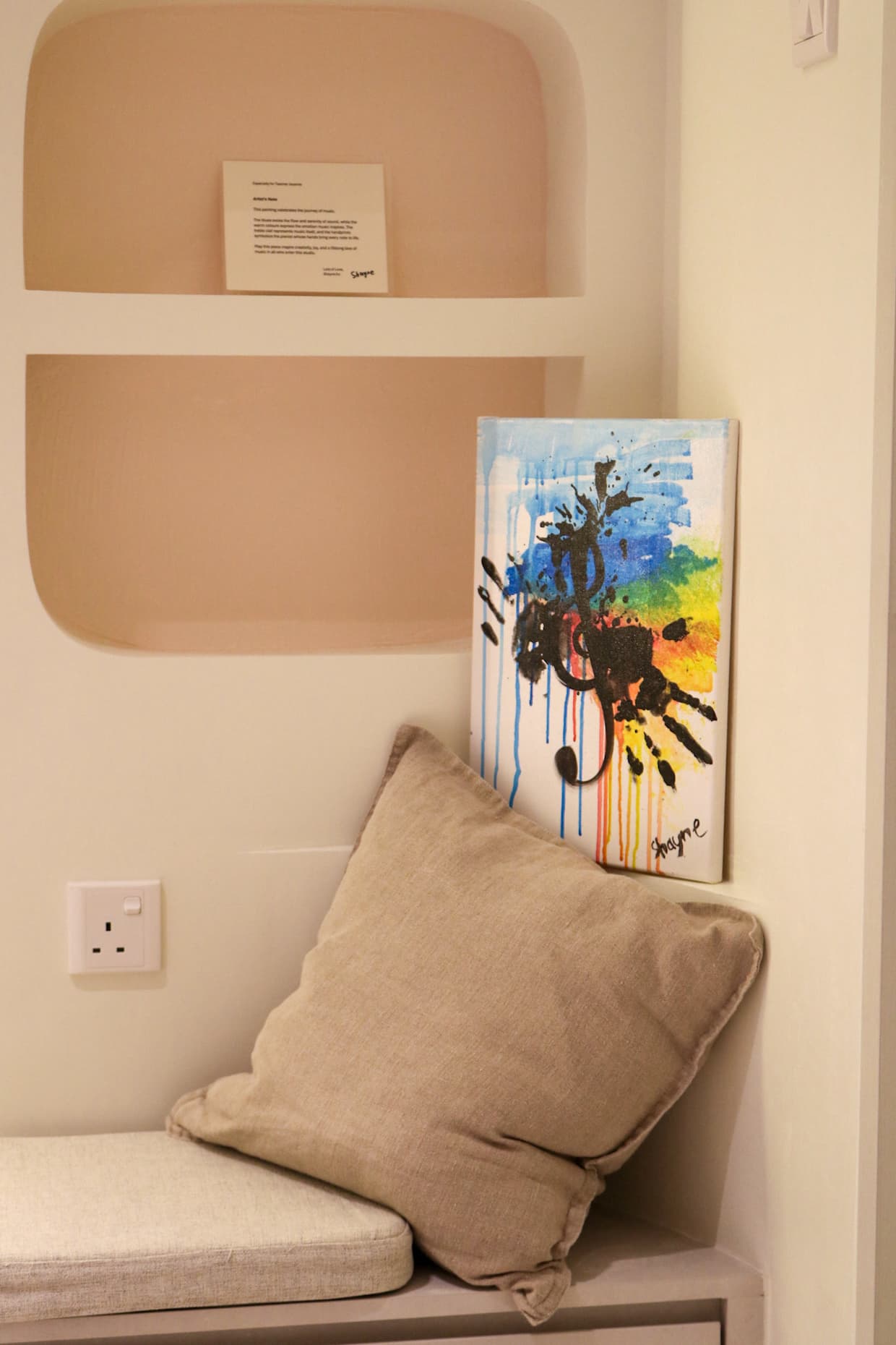 A hand-painted canvas gifted by a student, displayed in the studio's cosy corner