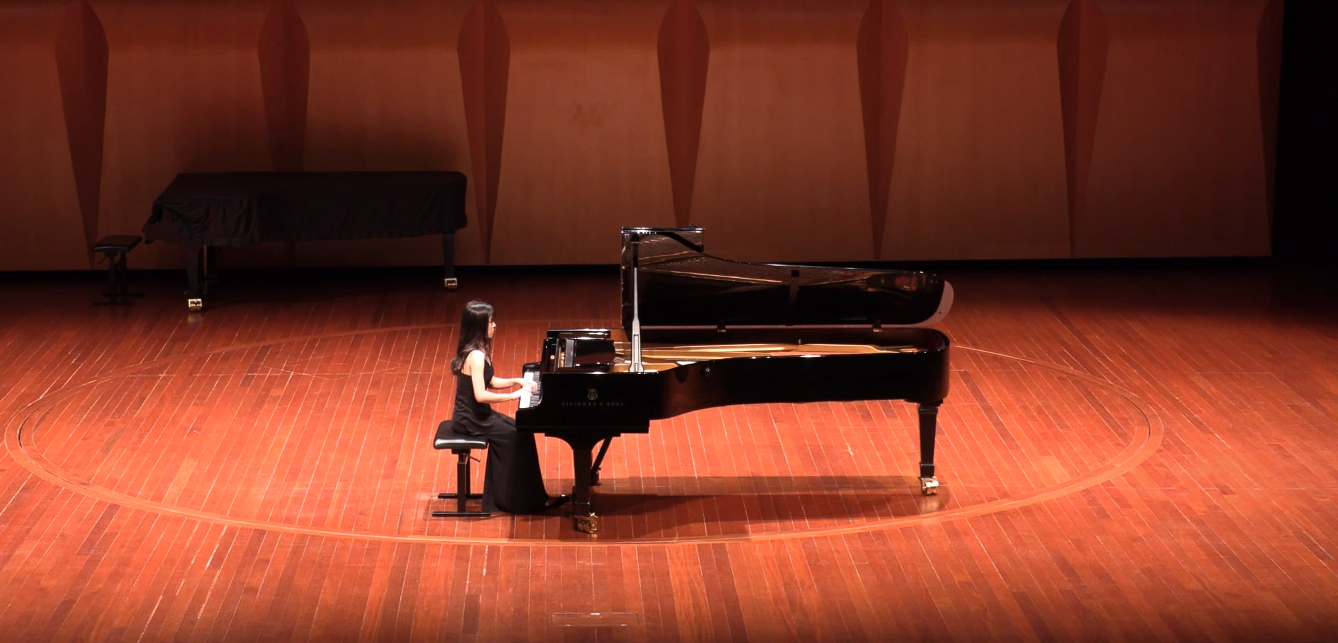 Jovanna Yam performing on stage in a concert hall