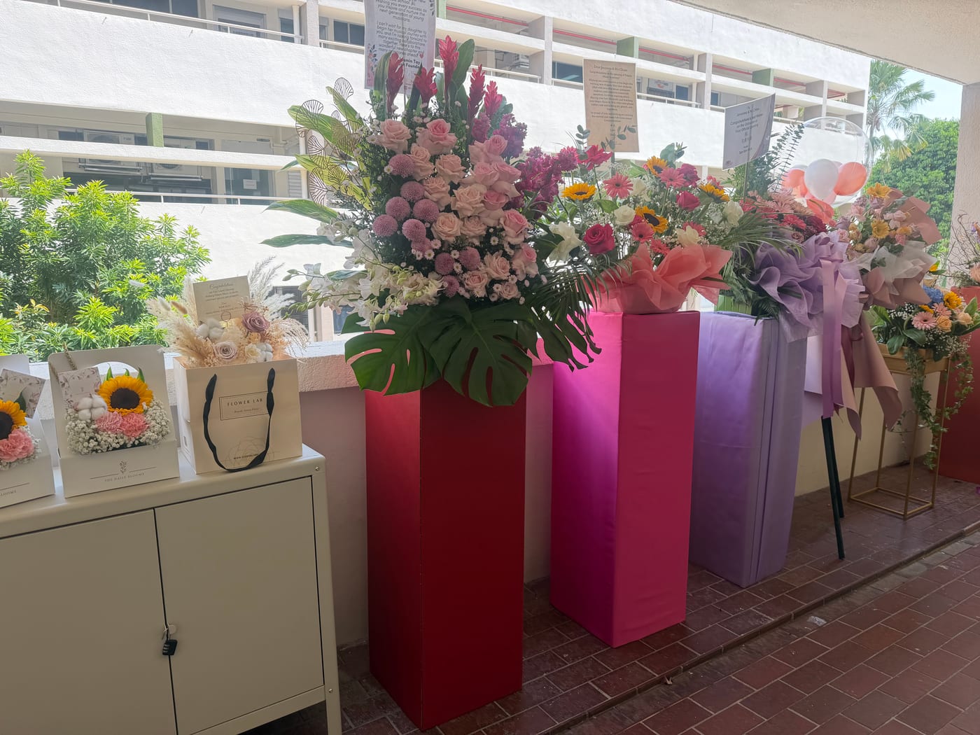 Congratulatory flower stands lining the corridor outside the studio